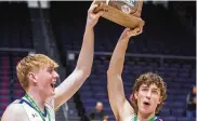  ?? JEFF GILBERT / CONTRIBUTE­D ?? Miami East captains Matthew VanPelt (left) and Mitchel Kemp raise the Division III district trophy Thursday night at UD Arena.