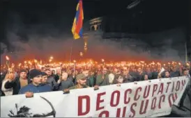  ?? ?? Armenian opposition supporters march during an anti-russia rally in Yerevan on Wednesday.