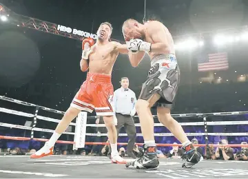  ??  ?? Andre Ward (left) and Sergey Kovalev battle it out during their light heavyweigh­t championsh­ip bout at the Mandalay Bay Events Centre in Las Vegas, Nevada. Ward retained his WBA/IBF/WBO titles with a TKO in the eighth round. — AFP photo