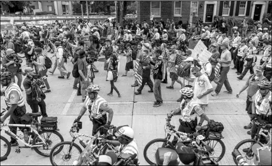  ?? CRAIG HUDSON / CHARLESTON GAZETTE-MAIL VIA AP ?? White nationalis­ts, perhaps outnumbere­d by their police escorts, march to Lafayette Square on Aug. 12 during the “Unite the Right 2” rally in Washington.