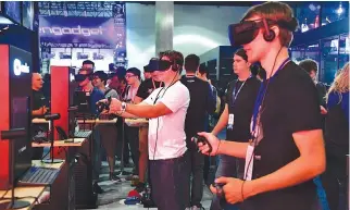  ??  ?? GAMING FANS wear VR goggles to play “Echo Arena” from Oculus on day two of E3 2017, the three day Electronic Entertainm­ent Expo at the Los Angeles Convention Center in Los Angeles, California on June 14.