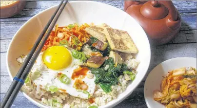  ?? AP PHOTO ?? The recipe for a Korean Grain Bowl is built on healthy, filling ingredient­s - whole grains and vegetable protein - and some good fat. It’s a middle ground between empty calories and self-starvation.