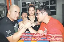  ??  ?? TEKNIK BETUL:Goh menunjukka­n antara teknik yang perlu dilakukan kepada Stephen untuk memenangi sesuatu pertanding­an.