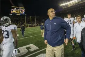  ?? TONY DING — THE ASSOCIATED PRESS ?? Penn State head coach James Franklin, center, walks off the Michigan Stadium field after an NCAA college football game against Michigan in Ann Arbor, Mich., Saturday.