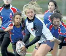  ?? CLIFFORD SKARSTEDT/EXAMINER FILES ?? Thomas A. Stewart Griffins' Lily Stewart attempts to pass the ball against the Cobourg Collegiate Wolves during Kawartha high school senior girls rugby AAA playoffs on Oct. 25 at Thomas A. Stewart Athletic Field. Stewart and Kyra Maybee of the Holy...