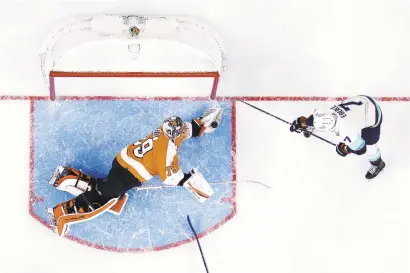  ?? MATT SLOCUM/AP ?? Flyers goalie Carter Hart blocks a shot by the Seattle Kraken’s Jordan Eberle during the first period of Monday night’s game in Philadelph­ia.