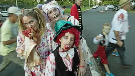  ??  ?? FEED ME BRAINS: Pausing on the Toowoomba Hospital Foundation’s Zombie Walk are (from left) Joanne Riddell, Natalie Ehrlich and Alex Riddell. PHOTOS: KEVIN FARMER