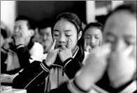  ??  ?? During a class break, students do eye exercises.