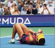  ?? Elise Amendola / Associated Press ?? Emma Raducanu lies on the court after defeating Leylah Fernandez to win the U.S. Open title on Saturday.