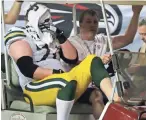  ?? RICK WOOD / MILWAUKEE JOURNAL SENTINEL ?? Green Bay Packers guard T.J. Lang is carted to the locker room after aggravatin­g a foot injury in Sunday’s game against the Atlanta Falcons.