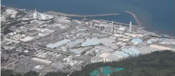  ?? — AFP photo ?? Aerial file picture shows storage tanks (bottom) used for storing treated water at Tepco’s crippled Fukushima Daiichi Nuclear Power Plant in Okuma, Fukushima prefecture.