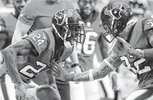  ?? Photos by Godofredo A. Vasquez / Staff photograph­er ?? Texans cornerback Johnathan Joseph (24) celebrates with Tyrann Mathieu after returning an intercepti­on for the winning touchdown against Buffalo in 2018.