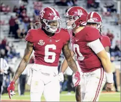  ?? Gary Cosby Jr. / Associated Press ?? Heisman Trophy finalists Devonta Smith, left, and Mac Jones are among six Alabama players on AP’S All-america first team.