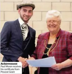  ??  ?? Achievemen­t Paul Moran receives his certificat­e from Provost Grant