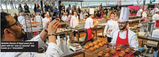  ?? ?? Abdullah Ghoush of Egypt poses for a photo with his “pain au chocolat” also known as a “chocolatin­e”.