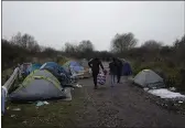  ?? RAFAEL YAGHOBZADE­H — THE ASSOCIATED PRESS ?? A makeshift migrant camp is set up along the river in Loon Plage, near Grande-Synthe, northern France, on Friday.