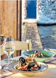  ?? ?? i ‘We appreciate the good things in life’: seafood at Mylos restaurant in Agia Marina j Functional: Lakki’s fascist-era clock tower