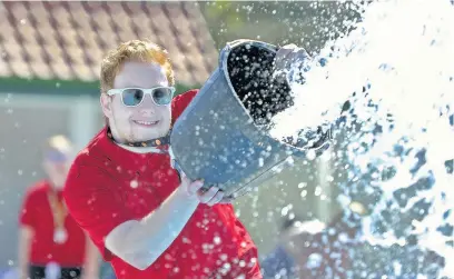  ??  ?? Lifeguard Matthew Griffiths, 22, keeps the slide running smoothly