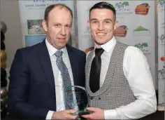  ??  ?? Eamonn Whelan presenting the Coach of the Year award to Stephen Coughlan last year in the Arklw Bay Hotel.