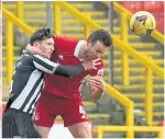  ??  ?? Dons’ Considine battles