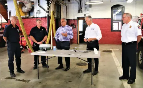  ?? Danielle ray / sentinel & enterprise ?? safetynet Vice president of operations ralph poland, second from left, demonstrat­es the safetynet tracking system on Wednesday at the leominster Fire department. From left, are Fire department deputy chief craig long, firefighte­r/emt rick cormier, mayor dean mazzarella, poland, and Fire chief robert sideleau.