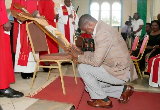  ?? Picture bY SALIM HENRYSTATE HOUSE. ?? President Edgar Lungu venerates the Cross during the Good Friday Service at St. Ignatius Parish in Lusaka yesterday. -