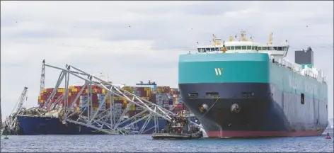  ?? MATT ROURKE/AP ?? A CARGO VESSEL moves through a newly opened deep-water channel in Baltimore after being stuck in the harbor since the Francis Scott Key Bridge collapsed four weeks ago on Thursday.