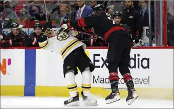 ?? AP ?? KNOCKED DOWN: Carolina’s Brett Pesce collides with Brad Marchand during the first period of Game 2 of their first-round playoff series in Raleigh, N.C., on Wednesday night.