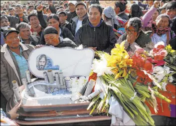  ?? Juan Karita The Associated Press ?? People mourn Saturday in Sacaba, Bolivia, next to the coffin of a supporter of former President Evo Morales killed during clashes with security forces.