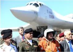  ??  ?? Padrino (second left) after the arrival of two Russian Tupolev Tu-160 strategic long-range heavy supersonic bomber aircrafts at Maiquetia Internatio­nal Airport, just north of Caracas. — AFP photo