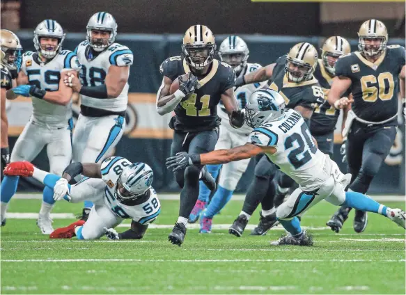  ??  ?? Saints running back Alvin Kamara (41) runs past Panthers free safety Kurt Coleman (20) on Dec. 3. The Saints won 31-21. DERICK E. HINGLE/USA TODAY SPORTS