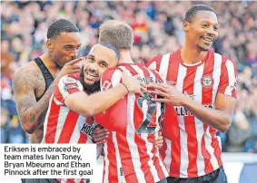  ?? ?? Eriksen is embraced by team mates Ivan Toney, Bryan Mbeumo and Ethan Pinnock after the first goal