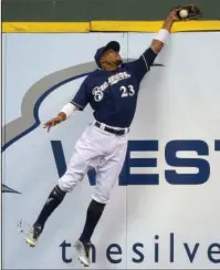  ?? The Associated Press ?? BACK, BACK, BACK: Milwaukee’s Keon Broxton robs St. Louis’ Jose Martinez of a hit in the second inning of the Brewers’ 2-1 victory Thursday over the visiting Cardinals.