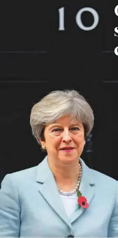  ?? AP ?? Britain’s Prime Minister Theresa May looks at the media from the doorstep of 10 Downing Street wearing her Royal British Legion poppy in London, on October 30.