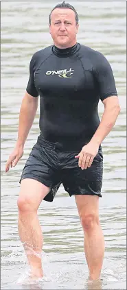  ?? Pictures: SPLASH ?? Chilly... David Cameron wore wet suit at beach