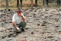  ??  ?? Richard Potts is seen with with artefacts in the Olorgesail­ie Basin in southern Kenya.