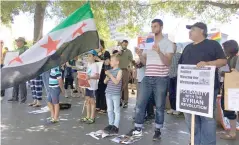  ??  ?? Dozens of people turned out in Auckland yesterday to support peace efforts in Syria.