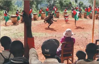  ??  ?? greets Chinese tourists at the Gishora drum sanctuary on the outskirts of Gitega, the second largest city in Burundi.