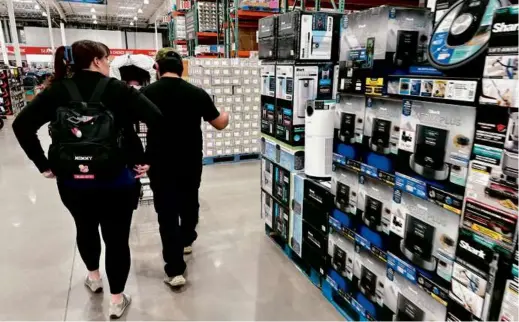  ?? DAVID ZALUBOWSKI/ASSOCIATED PRESS ?? Shoppers in a Costco warehouse in Timnath, Colo. Consumer spending accounts for about 70 percent of US economic activity, so economists pay close attention to consumer behavior as they take measure of the broader economy.