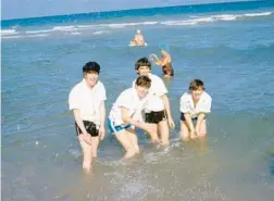  ?? AP ?? John Lennon, from left, Paul McCartney, George Harrison and Ringo Starr splash around in the Atlantic Ocean at a Florida beach in February 1964. Bob Kealing will present “Good Day Sunshine: The Beatles in 1964 Florida” on March 19 as part of an Orange County Regional History Center lecture series.