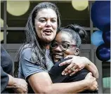  ??  ?? Superinten­dent Meria Carstarphe­n gives Harper-Archer Elementary School fifth grader Simora Gaines a hug Thursday after the ribbon-cutting ceremony at the newly renovated school.