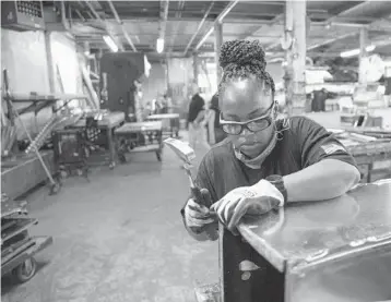  ?? KEVIN HAGEN/AP ?? Sheet metal worker Carey Mercer assembles ductwork Aug. 3 in New York. The constructi­on industry is fighting to recruit more women.