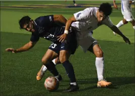  ?? PHOTO BY MILKA SOKO ?? Cal Baptist’s Uly Martinez protects the ball from UC Riverside’s Edward Castro in a nonconfere­nce men’s soccer match at UCR on Saturday. The match ended in a 1-1 tie.