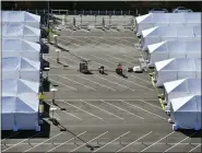  ?? JEFF GRITCHEN/THE ORANGE COUNTY REGISTER VIA AP ?? COVID-19vaccinat­ion tents are set up in the north of the Toy Story parking lot at the Disneyland Resort on Tuesday, Jan. 12, 2021, in Anaheim, Calif. The parking lot is located off Katella Avenue and sits southeast of Disneyland.