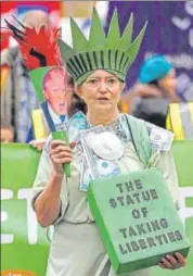  ?? REUTERS ?? A protester demonstrat­es in central London on Sunday ahead of the United Nations climate change conference in Poland.