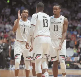  ?? AP PHOTO ?? BEARCAT BUNCH: Cincinnati guard Jacob Evans (1) and forwards Tre Scott (13) and Gary Clark celebrate in the second half of the Bearcats’ victory over Georgia State yesterday in Nashville, Tenn.