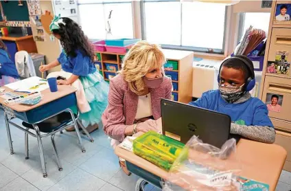  ?? Mandel Ngan / Associated Press ?? First lady Jill Biden speaks with a student as she tours Benjamin Franklin Elementary School on Wednesday in Meriden, Conn.