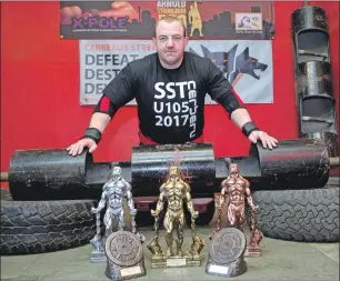  ??  ?? Stuart Whyte prepares for this weekend’s strongman event at the Nevis Centre.