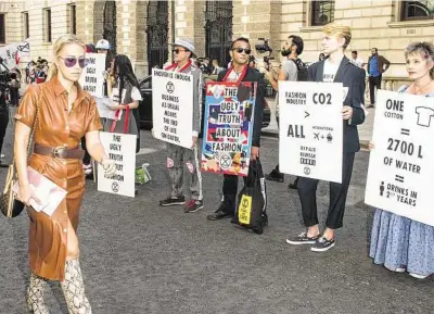  ??  ?? Extinction Rebellion, or XR, protesters rally outside the Victoria Beckham show during London Fashion Week. XR, a direct action climate movement, has swelled to millions of followers.