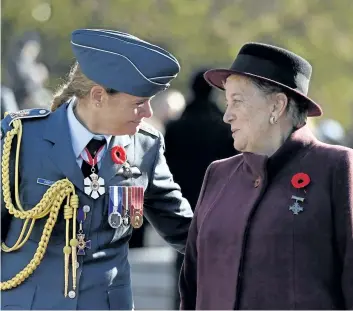  ?? JUSTIN TANG/THE CANADIAN PRESS ?? Governor General Julie Payette speaks with 2017 National Silver Cross Mother Diana Abel, right, during the march past during the National Remembranc­e Day Ceremony at the National War Memorial in Ottawa on Saturday.